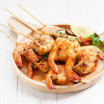 shrimp sriracha kebabs with lime and cilantro leaves