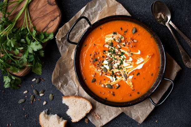 Creamy pumpkin soup is a warm and comforting dish that captures the essence of fall flavors. With its rich and velvety texture, this soup is a perfect starter for your Thanksgiving feast. It's not only delicious but also packed with nutrients, making it a wholesome addition to your holiday table.

Difficulty: Easy
Prep Time: 10 mins
Cook Time: 30 mins
Total Time: 40 mins
Cooking Temp: Medium heat
Estimated Cost: $8
Calories: 150 kcal per serving
Best Season: Fall

Description
This pumpkin soup is smooth and creamy, flavored with warm spices and a hint of sweetness. It's a perfect appetizer that sets the tone for a festive meal. Whether served hot or warm, this comforting soup is sure to please your guests and become a staple in your Thanksgiving menu.

Ingredients
1 can (15 oz) pumpkin puree
2 cups vegetable broth
1 cup coconut milk (or heavy cream)
1 onion, chopped
2 cloves garlic, minced
1 tsp ground cinnamon
1/2 tsp nutmeg
Salt and pepper to taste
Optional: pumpkin seeds for garnish
Instructions
Sauté the vegetables: In a large pot, heat a little olive oil over medium heat. Add the chopped onion and sauté until translucent, about 5 minutes. Add the minced garlic and cook for an additional minute.

Add pumpkin and broth: Stir in the pumpkin puree, vegetable broth, coconut milk, cinnamon, and nutmeg. Bring to a simmer and cook for 15-20 minutes, allowing the flavors to meld.

Blend the soup: Using an immersion blender or a regular blender, blend the soup until smooth. If using a regular blender, be sure to allow steam to escape while blending.

Season and serve: Taste and adjust seasoning with salt and pepper as needed. Serve hot, garnished with pumpkin seeds if desired.

Nutrition Facts (per serving)
Calories: 150 kcal
Calories from Fat: 70 kcal
Total Fat: 8g
Saturated Fat: 6g
Cholesterol: 0mg
Sodium: 250mg
Total Carbohydrate: 18g
Dietary Fiber: 3g
Sugars: 4g
Protein: 3g
Notes
Storage: Store leftovers in an airtight container in the refrigerator for up to 4 days. Reheat on the stovetop or in the microwave.
Customization: For extra flavor, add a pinch of cayenne pepper or a splash of maple syrup for sweetness.
Serving Suggestion: Serve with crusty bread or crackers for dipping.
